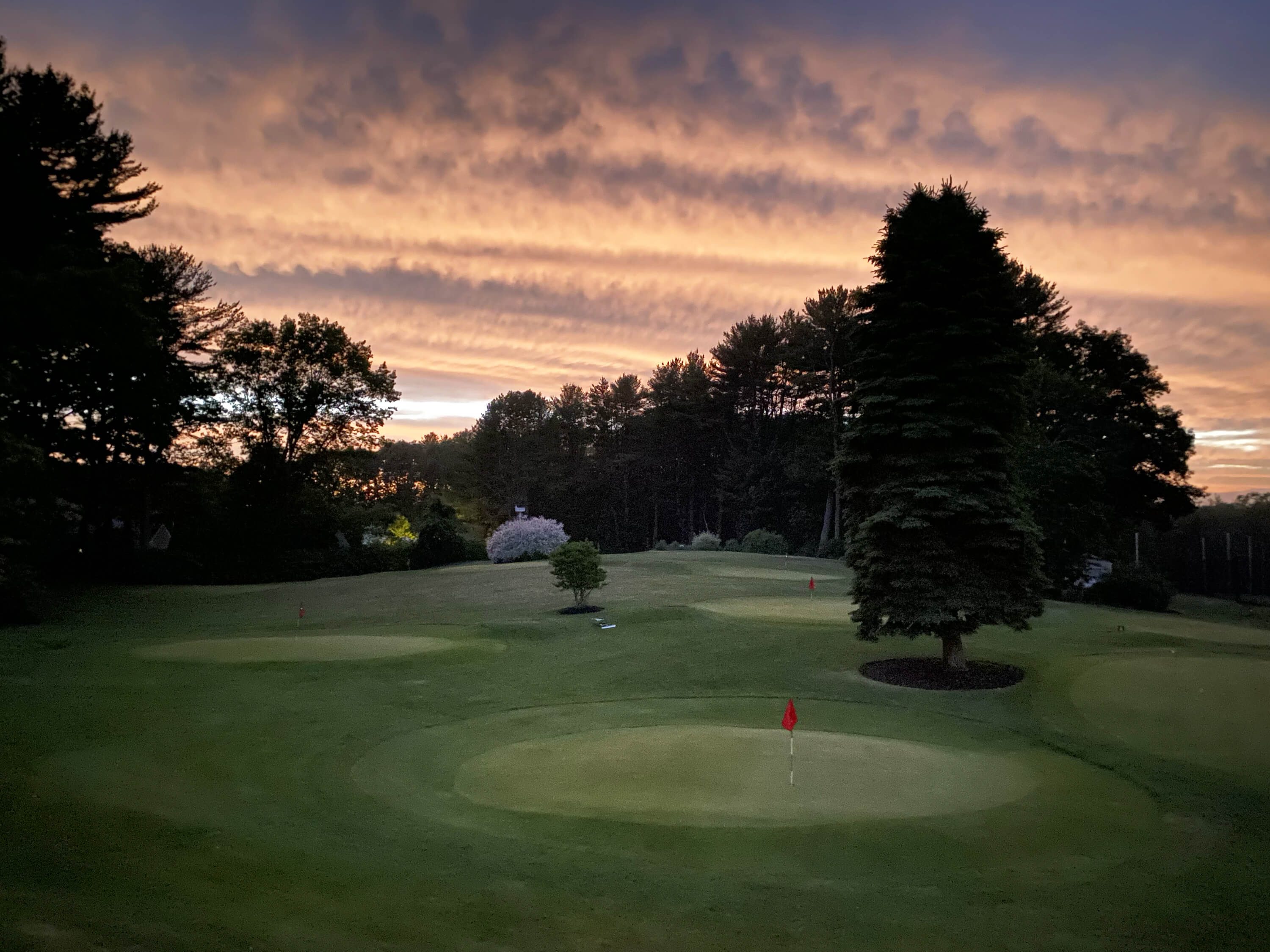 Pitch and putt greens at sunset